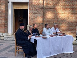 duhovno predavanje u porti crkve u Čajetini, govornici i vjernici na otvorenom prostoru pored crkve tokom predavanja - Predavanje na otvorenom u porti crkve u Čajetini sa slušaocima okupljenim na klupama